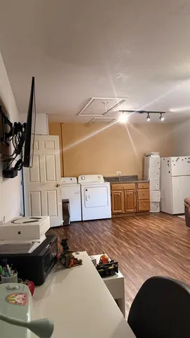 a view of a livingroom with furniture wooden floor and window
