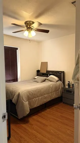 a view of a patio with table and chairs potted plants and large tree