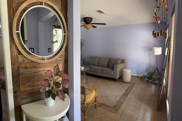 a living room with furniture and a mirror