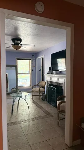 a living room with furniture and a fireplace
