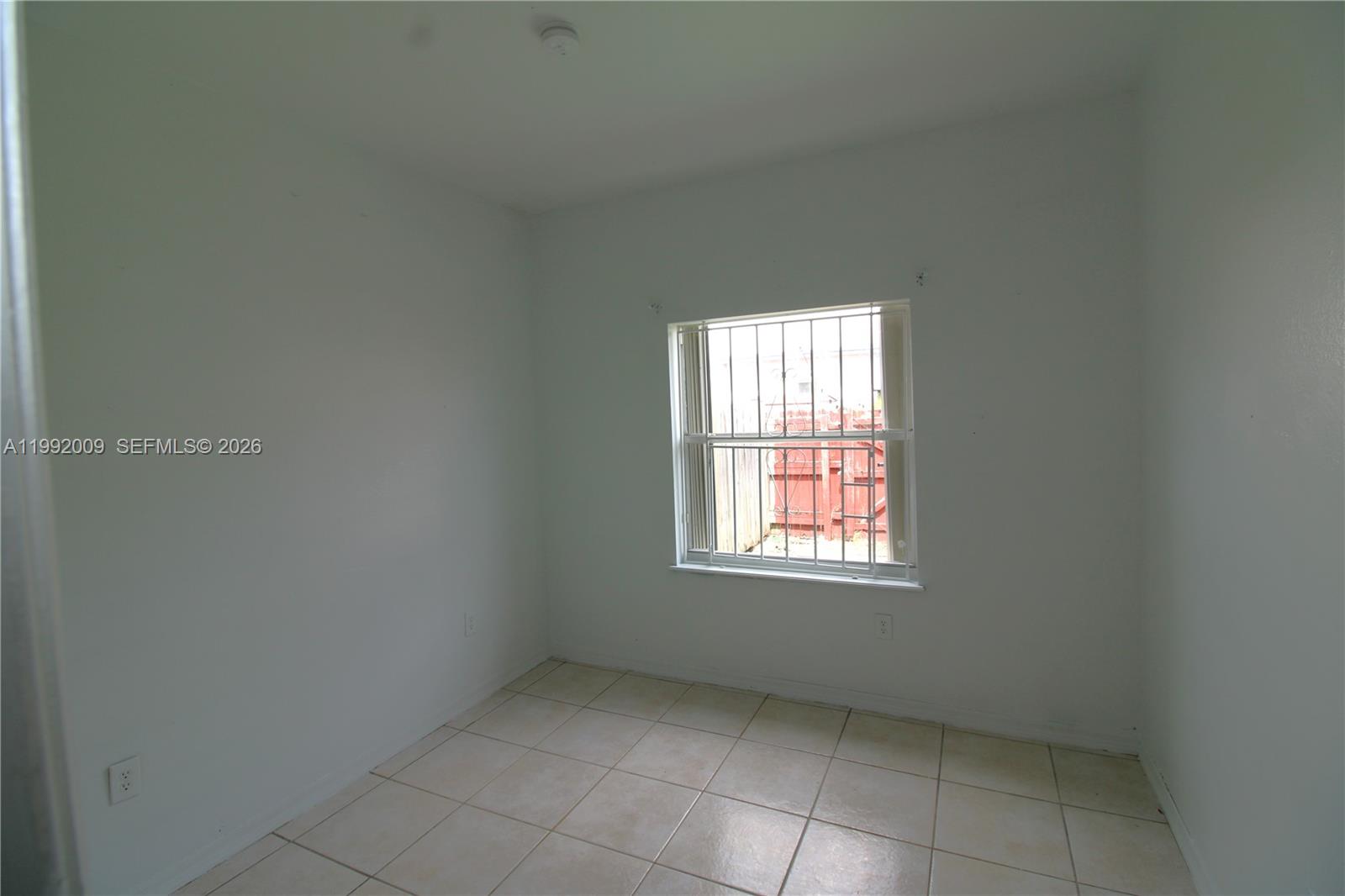 13929 Southwest 282nd Street Homestead, FL 33033 - Photo 14 of 30 an empty room with a window