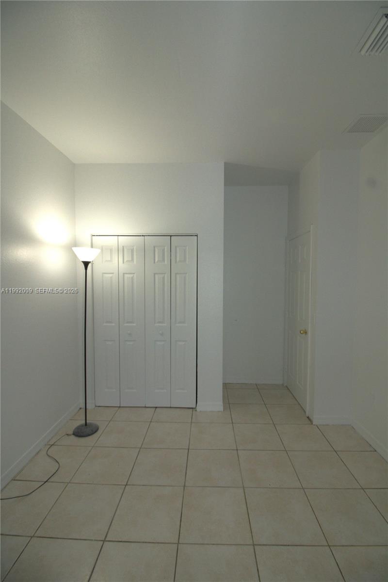13929 Southwest 282nd Street Homestead, FL 33033 - Photo 16 of 30 an empty room with a mirror