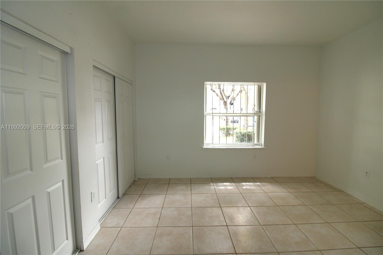 13929 Southwest 282nd Street Homestead, FL 33033 - Photo 17 of 30 a view of an empty room with a window