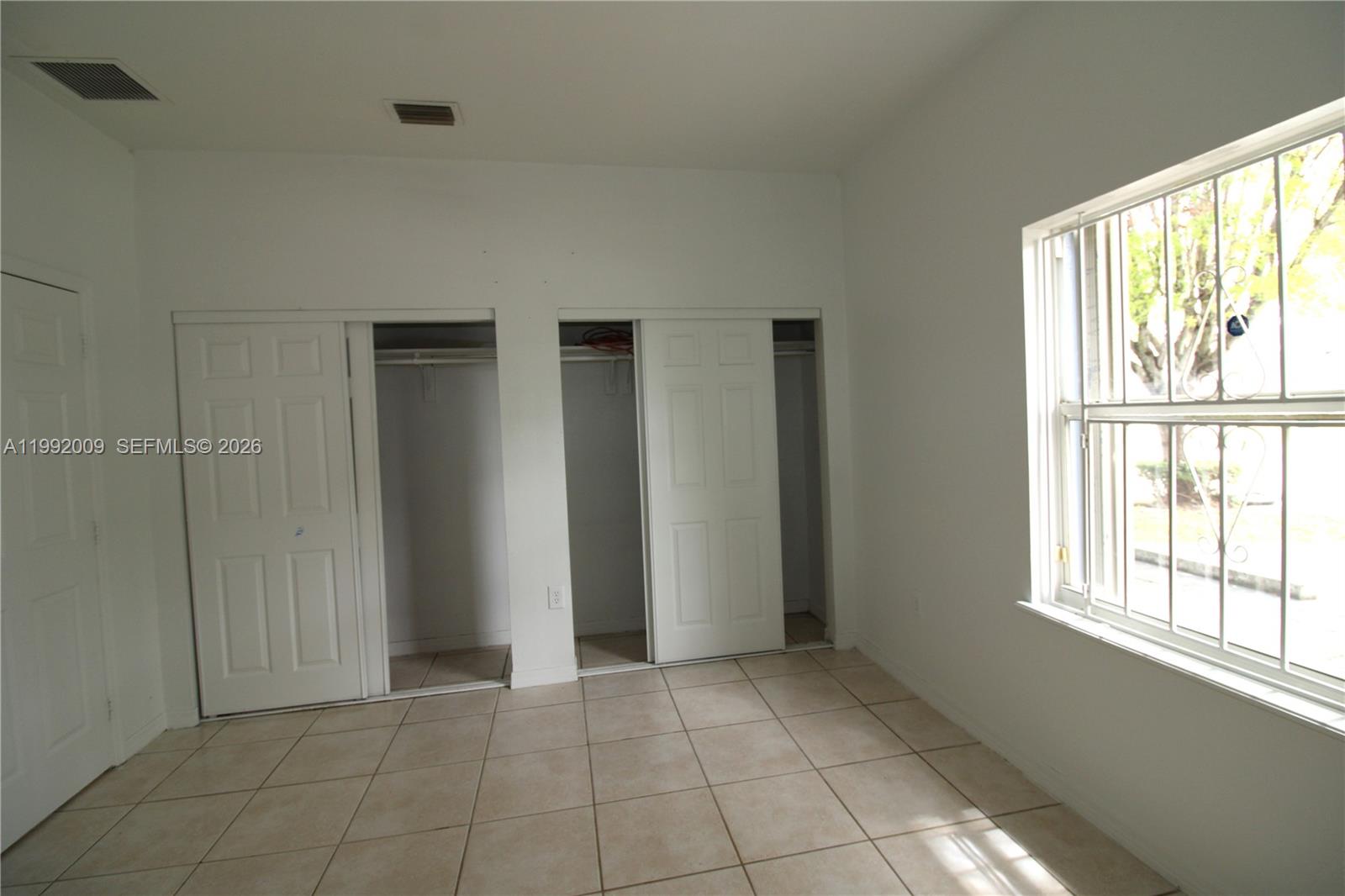 13929 Southwest 282nd Street Homestead, FL 33033 - Photo 19 of 30 a view of an empty room with a window