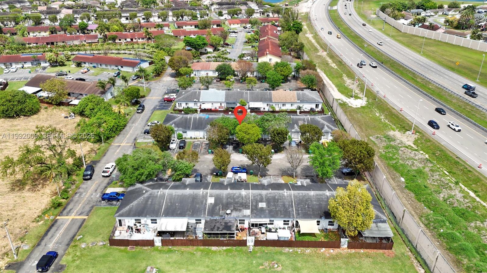 13929 Southwest 282nd Street Homestead, FL 33033 - Photo 2 of 30 an aerial view of a city with lots of residential buildings ocean and mountain view in back