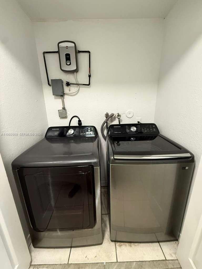 13929 Southwest 282nd Street Homestead, FL 33033 - Photo 22 of 30 a close view of a stove a microwave and door