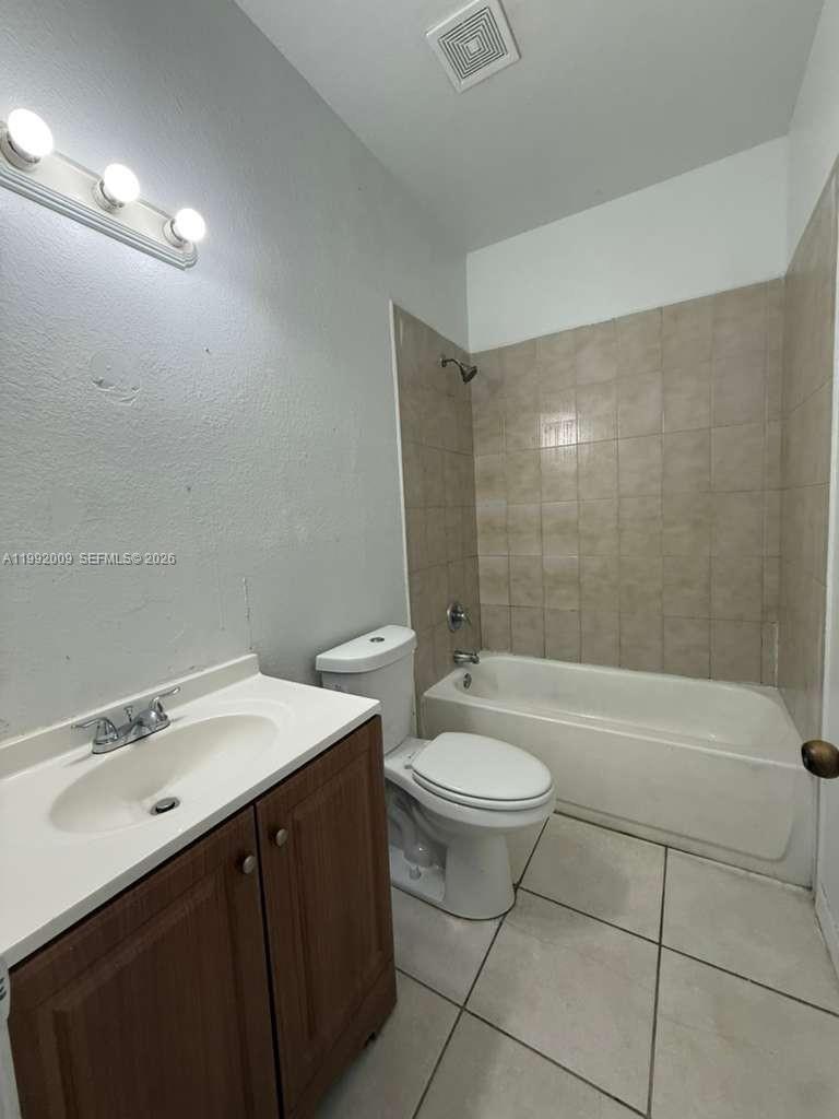 13929 Southwest 282nd Street Homestead, FL 33033 - Photo 23 of 30 a bathroom with a sink a toilet and bathtub