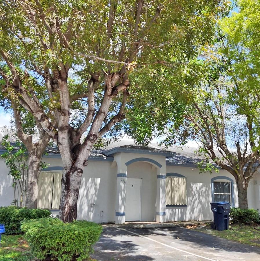 13929 Southwest 282nd Street Homestead, FL 33033 - Photo 6 of 30 a front view of a house with a tree