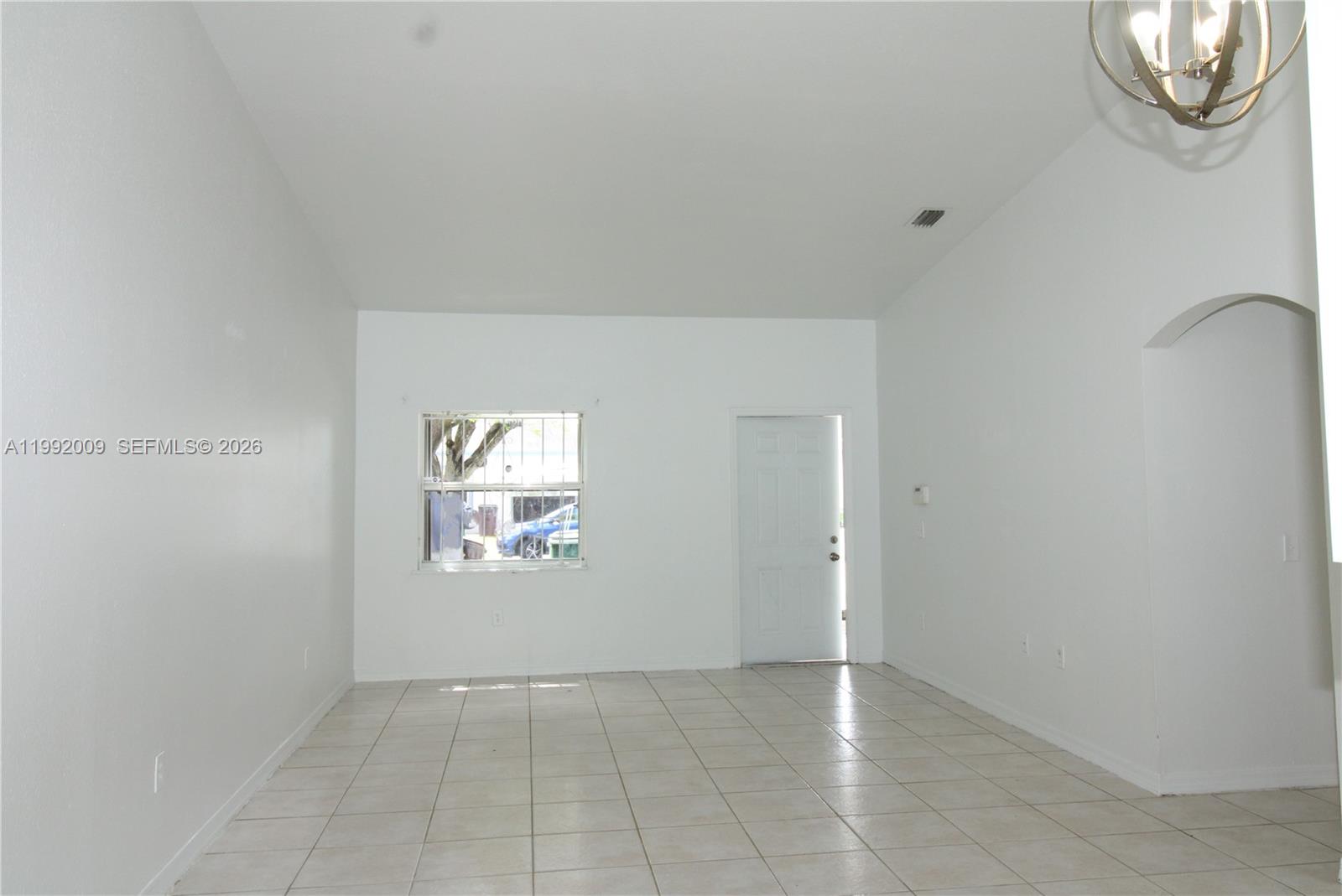 13929 Southwest 282nd Street Homestead, FL 33033 - Photo 7 of 30 an empty room with windows and mirror