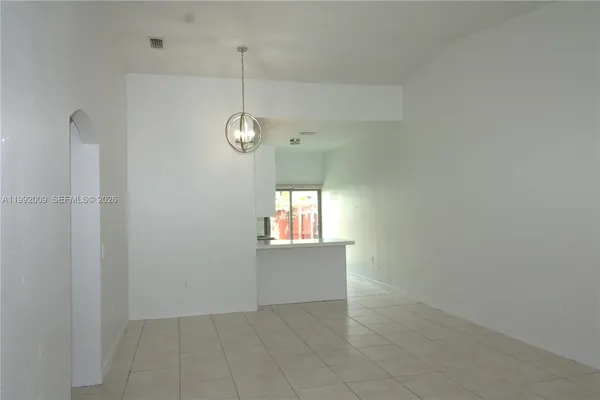 an empty room with windows and entrance