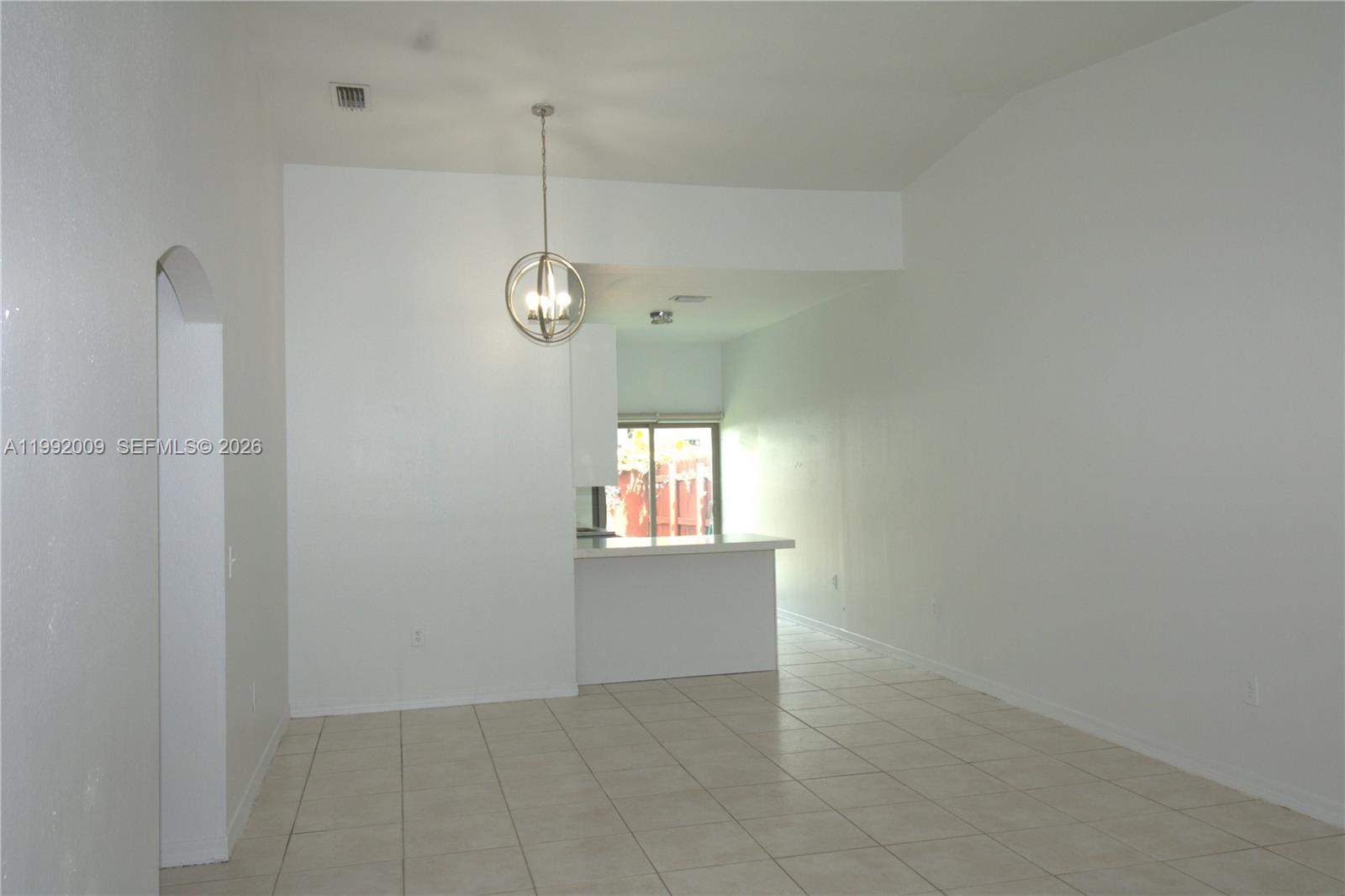 13929 Southwest 282nd Street Homestead, FL 33033 - Photo 8 of 30 an empty room with windows and entrance