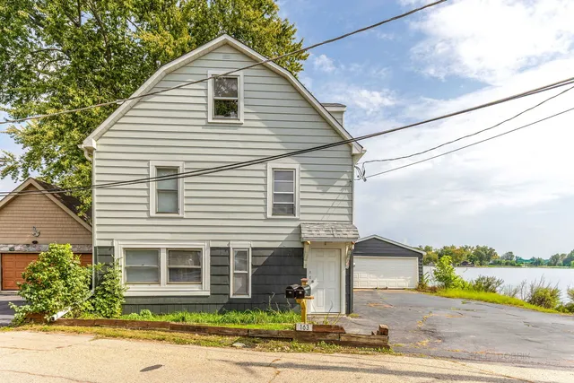 a view of a house with a yard and plants