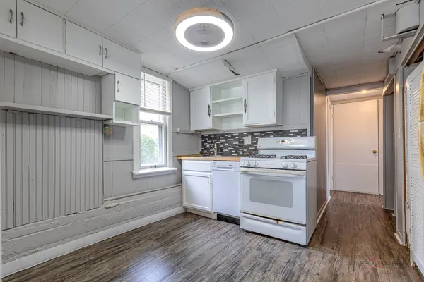 a view of a room with wooden floor and windows