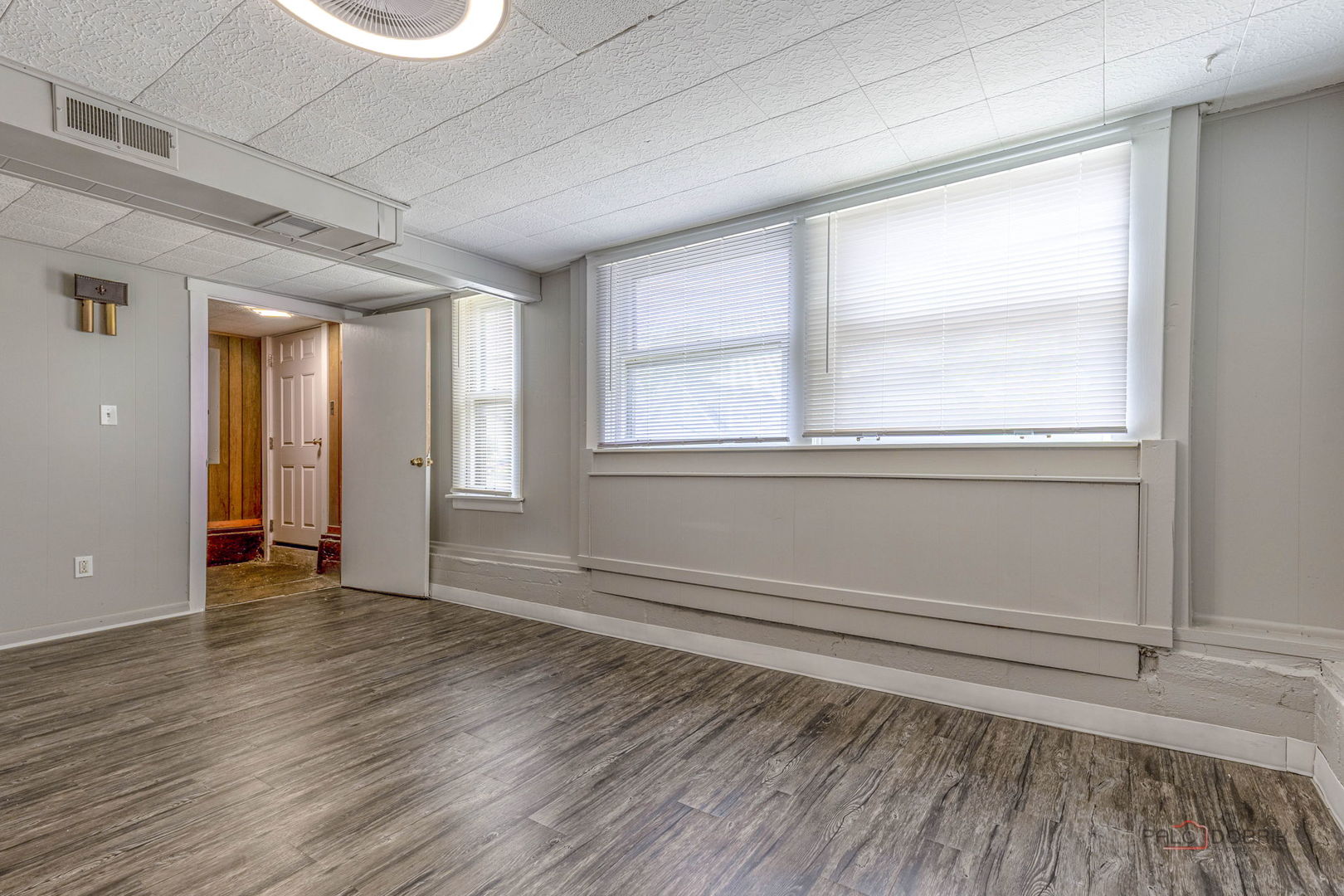 163 Eagle Point Road, Unit 1 Fox Lake, IL 60020 - Photo 8 of 26 a view of an empty room with wooden floor and a window