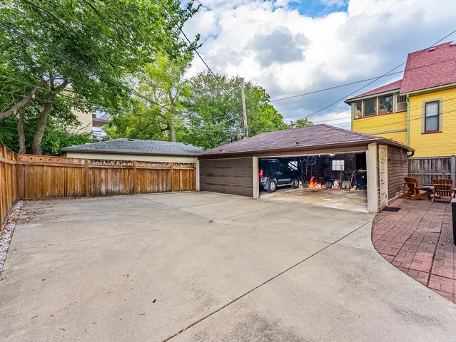 a view of a house with backyard and sitting area