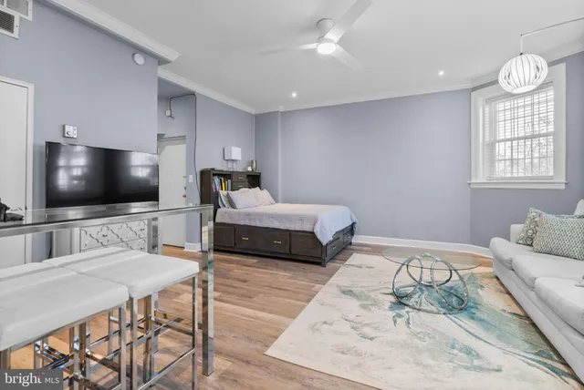 a bedroom with furniture and a flat screen tv