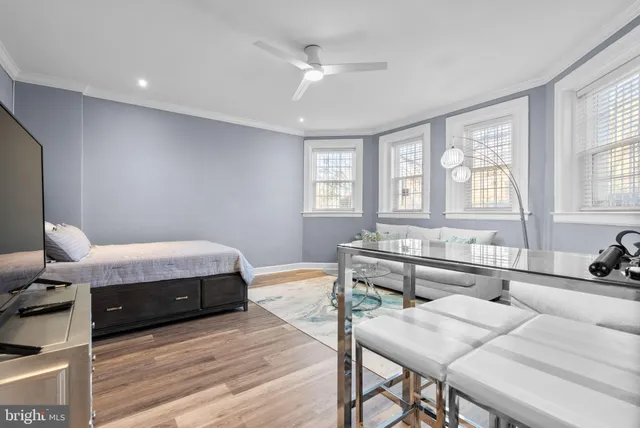 a bedroom with a bed and a table chair