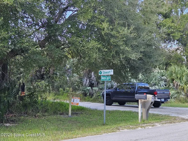 a wooden bench sitting in front of a building