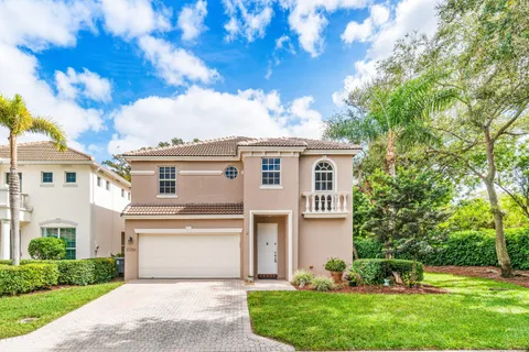 a front view of a house with a garden and plants