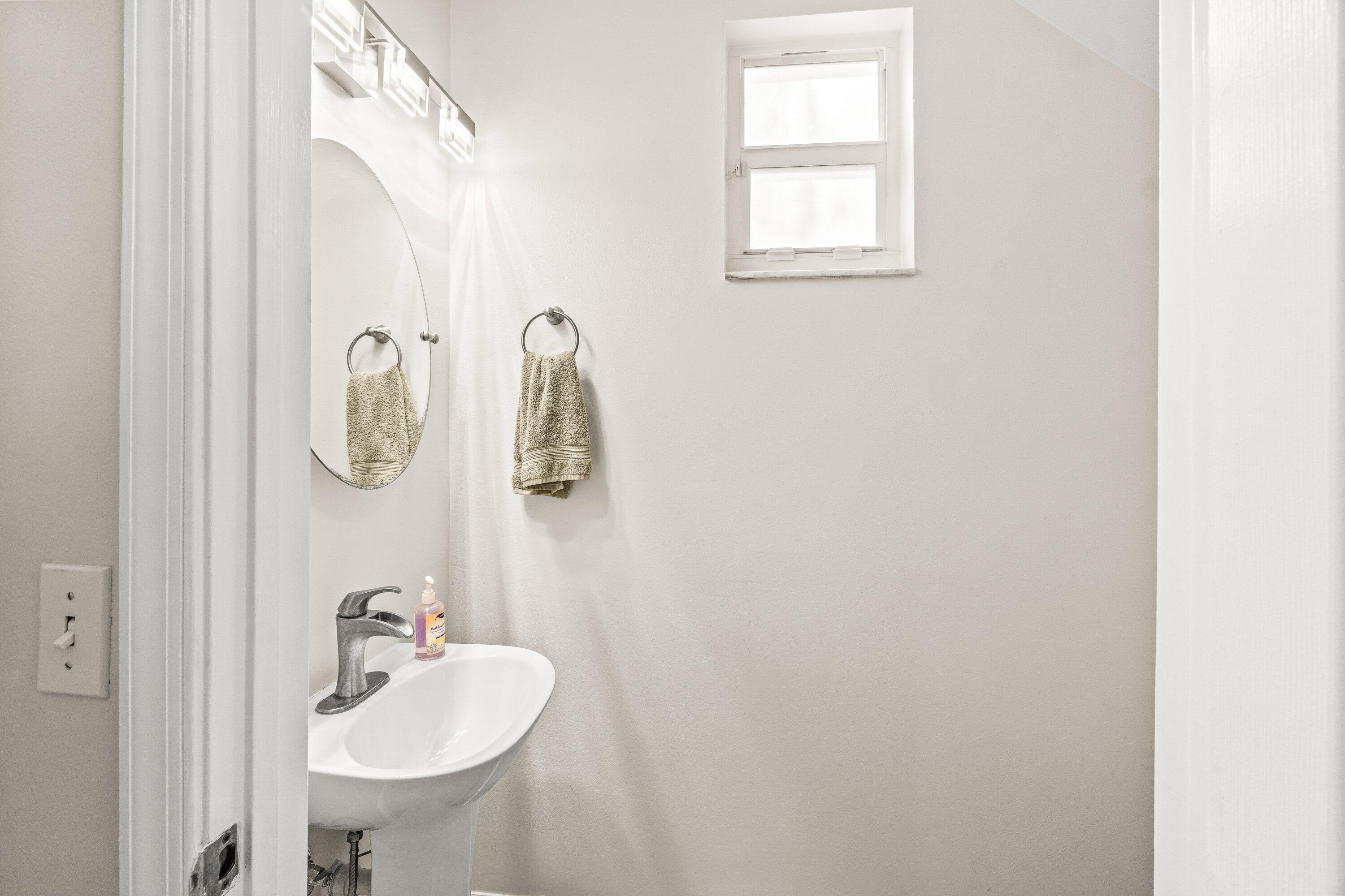 21256 Vía Fiore Boca Raton, FL 33433 - Photo 11 of 42 a bathroom with a sink and mirror with window