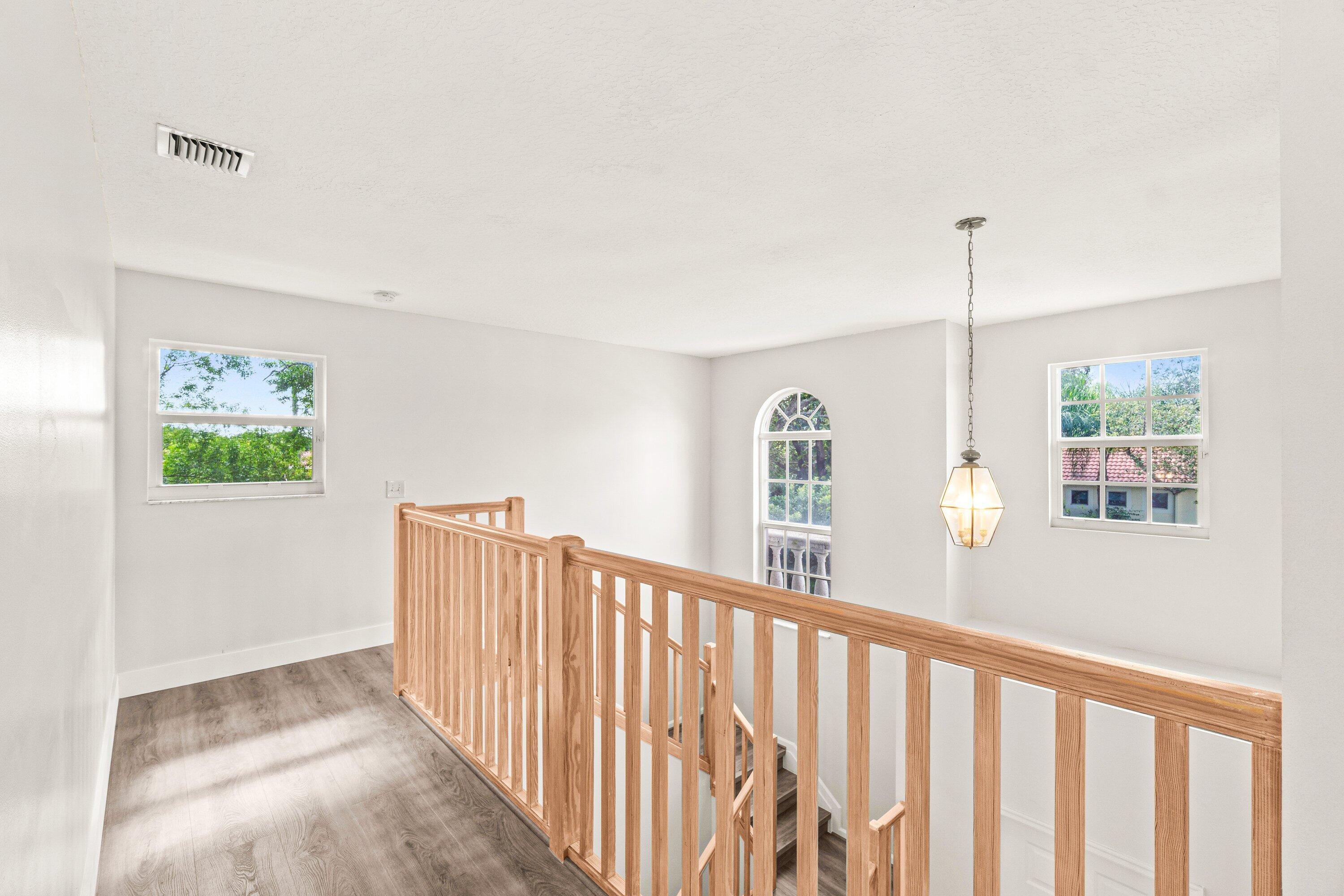 21256 Vía Fiore Boca Raton, FL 33433 - Photo 24 of 42 a view of a hallway with windows