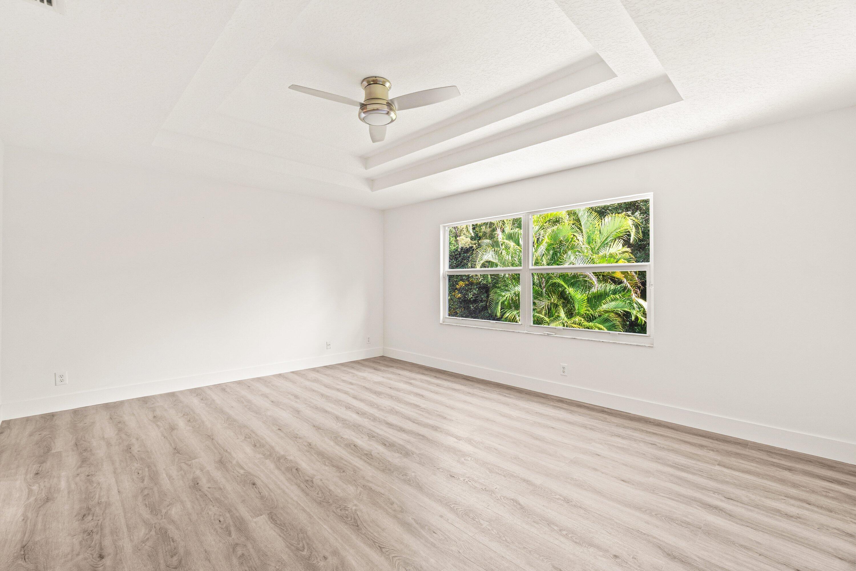 21256 Vía Fiore Boca Raton, FL 33433 - Photo 26 of 42 wooden floor in an empty room with a window