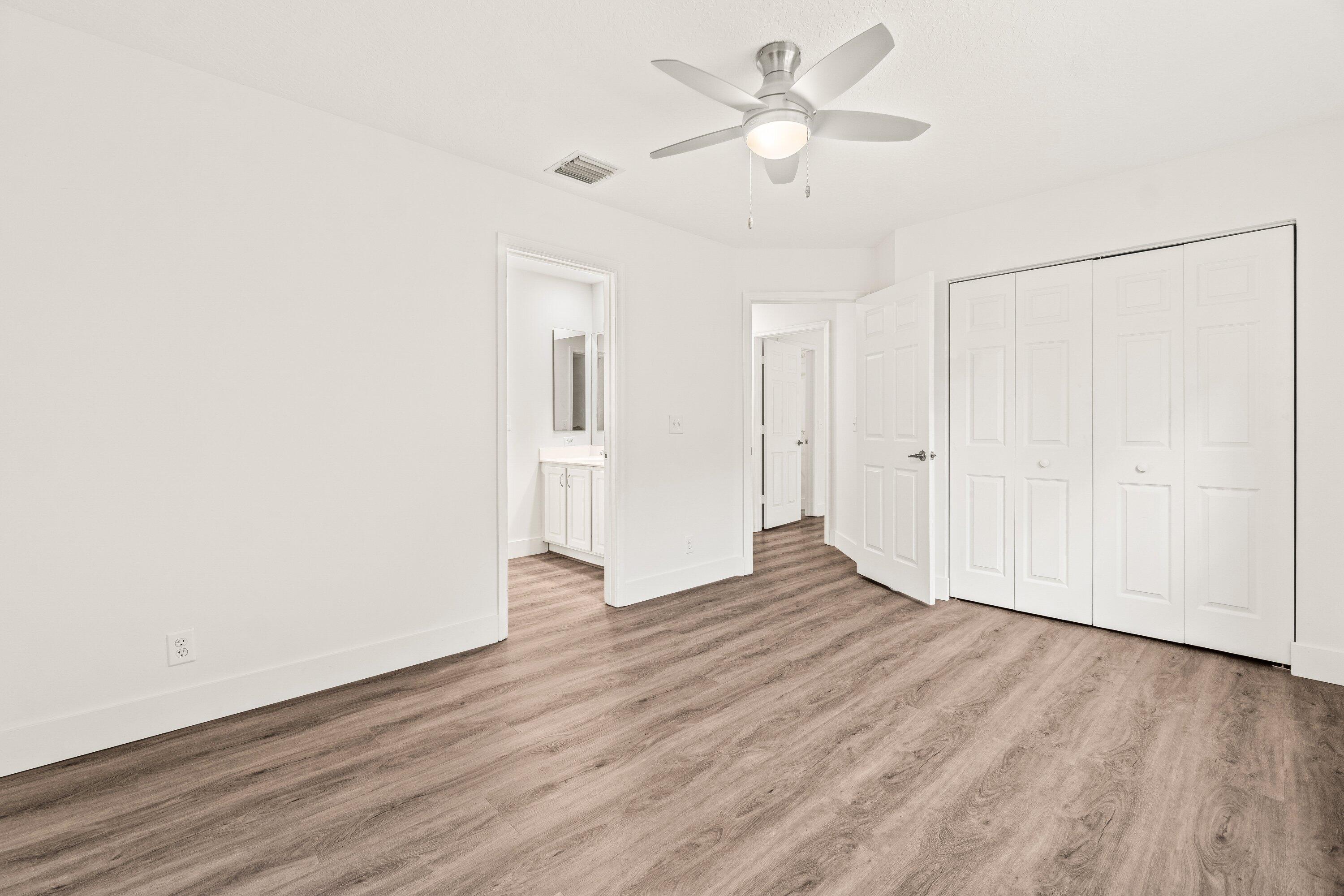 21256 Vía Fiore Boca Raton, FL 33433 - Photo 31 of 42 an empty room with wooden floor ceiling fan