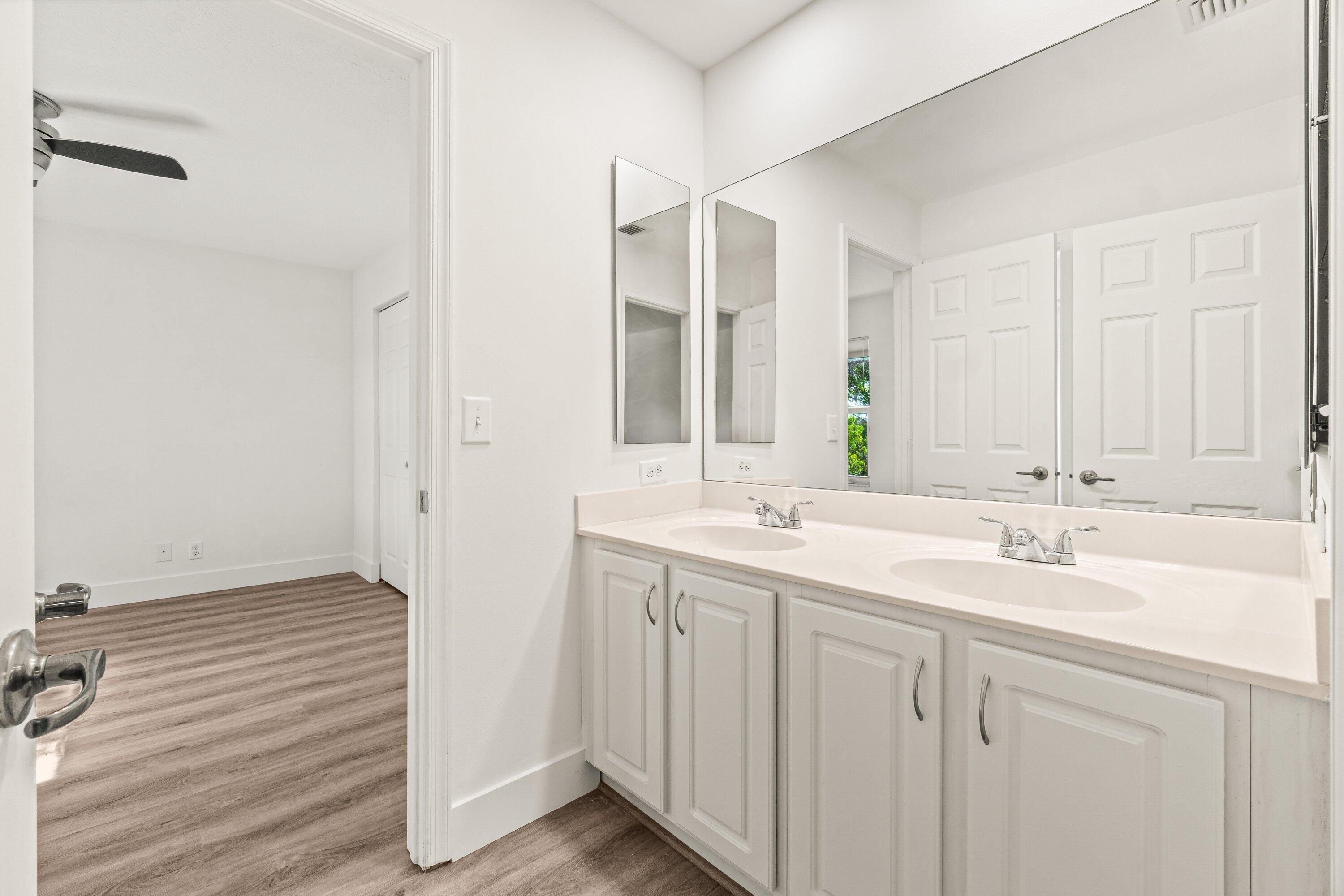 21256 Vía Fiore Boca Raton, FL 33433 - Photo 32 of 42 a bathroom with 2 sink and a mirror