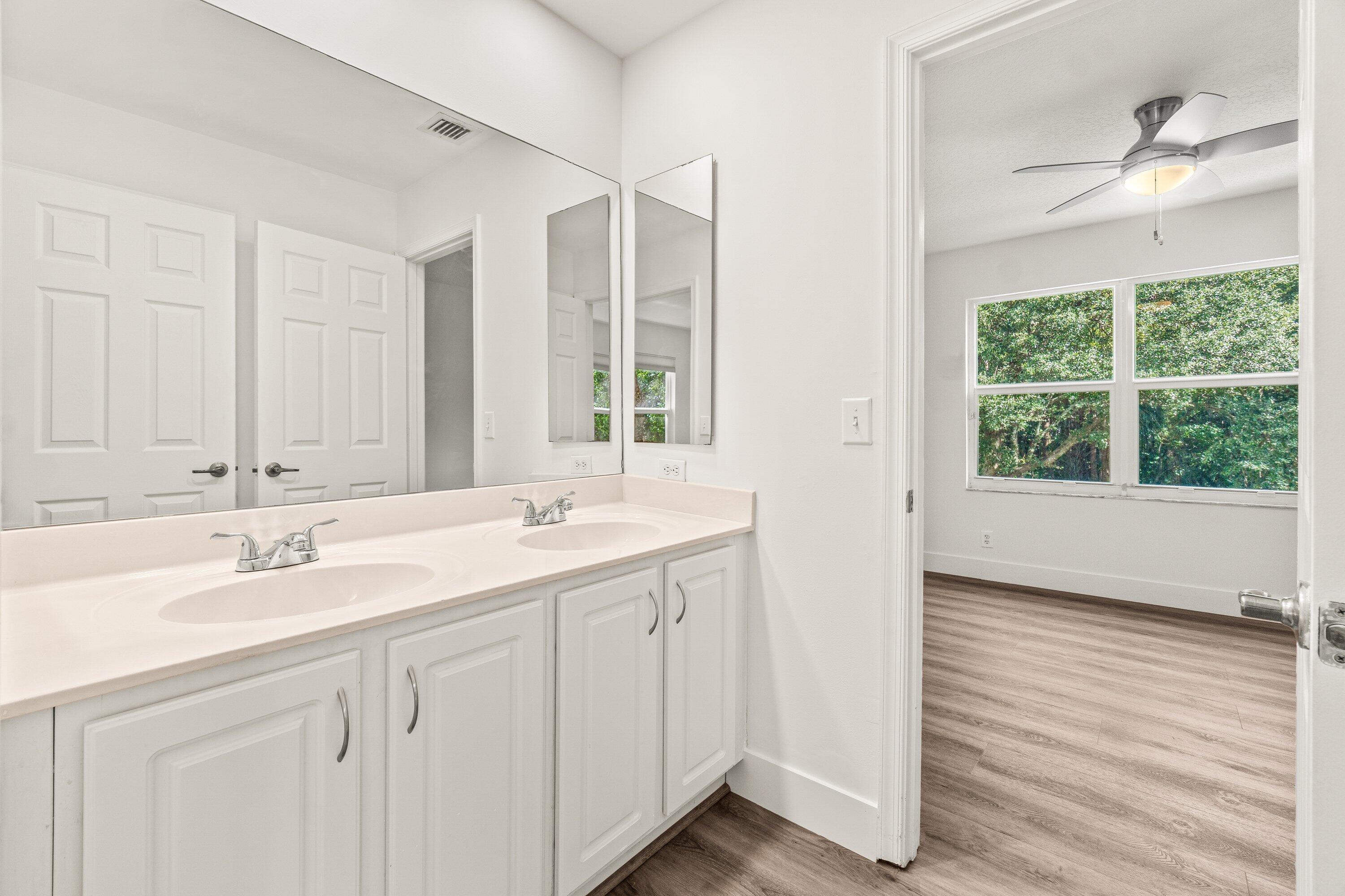 21256 Vía Fiore Boca Raton, FL 33433 - Photo 33 of 42 a bathroom with a sink double vanity and a mirror