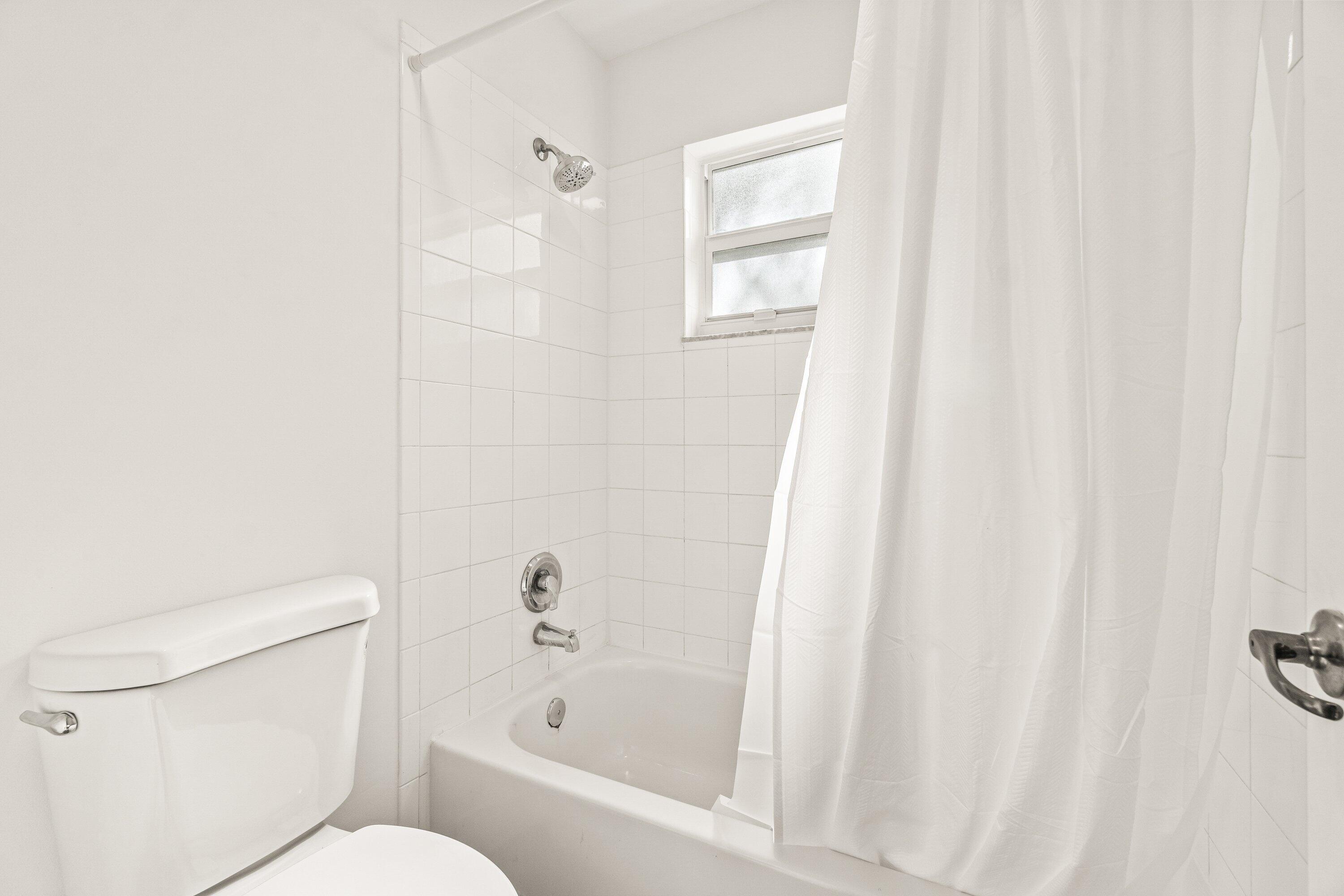 21256 Vía Fiore Boca Raton, FL 33433 - Photo 34 of 42 a white toilet sitting next to a bath tub