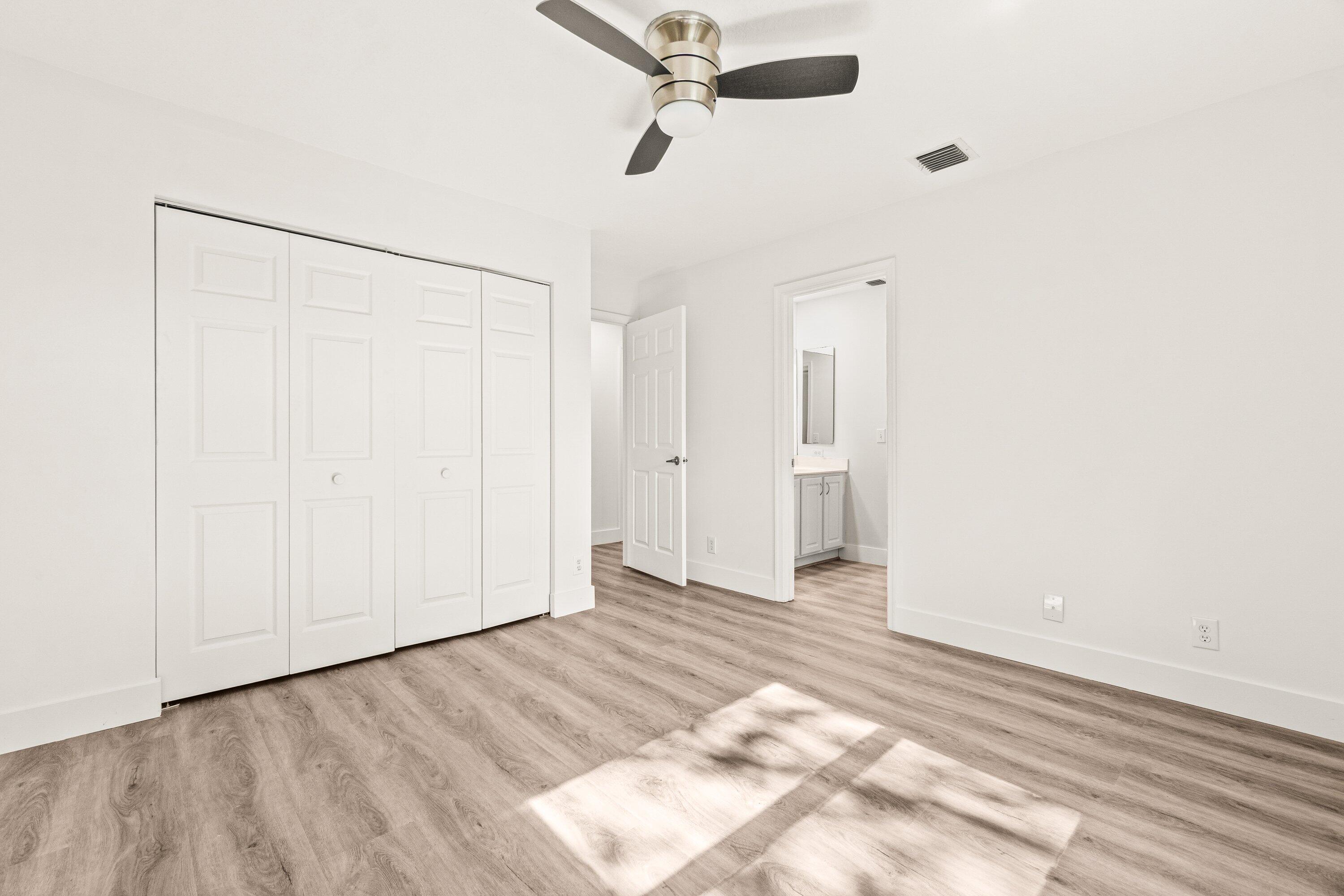 21256 Vía Fiore Boca Raton, FL 33433 - Photo 36 of 42 a view of an empty room with a ceiling fan