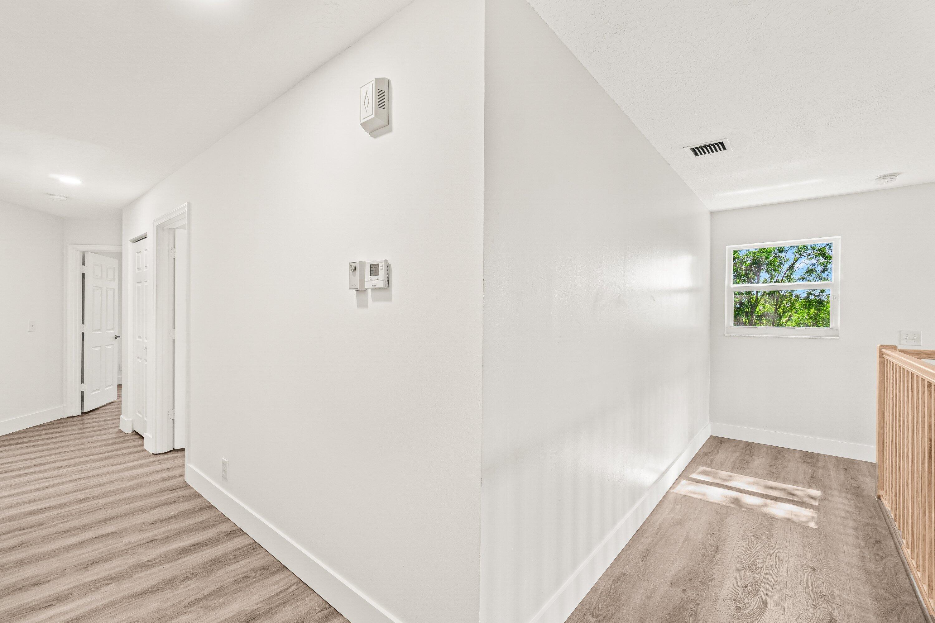 21256 Vía Fiore Boca Raton, FL 33433 - Photo 37 of 42 a view of a hallway with wooden floor