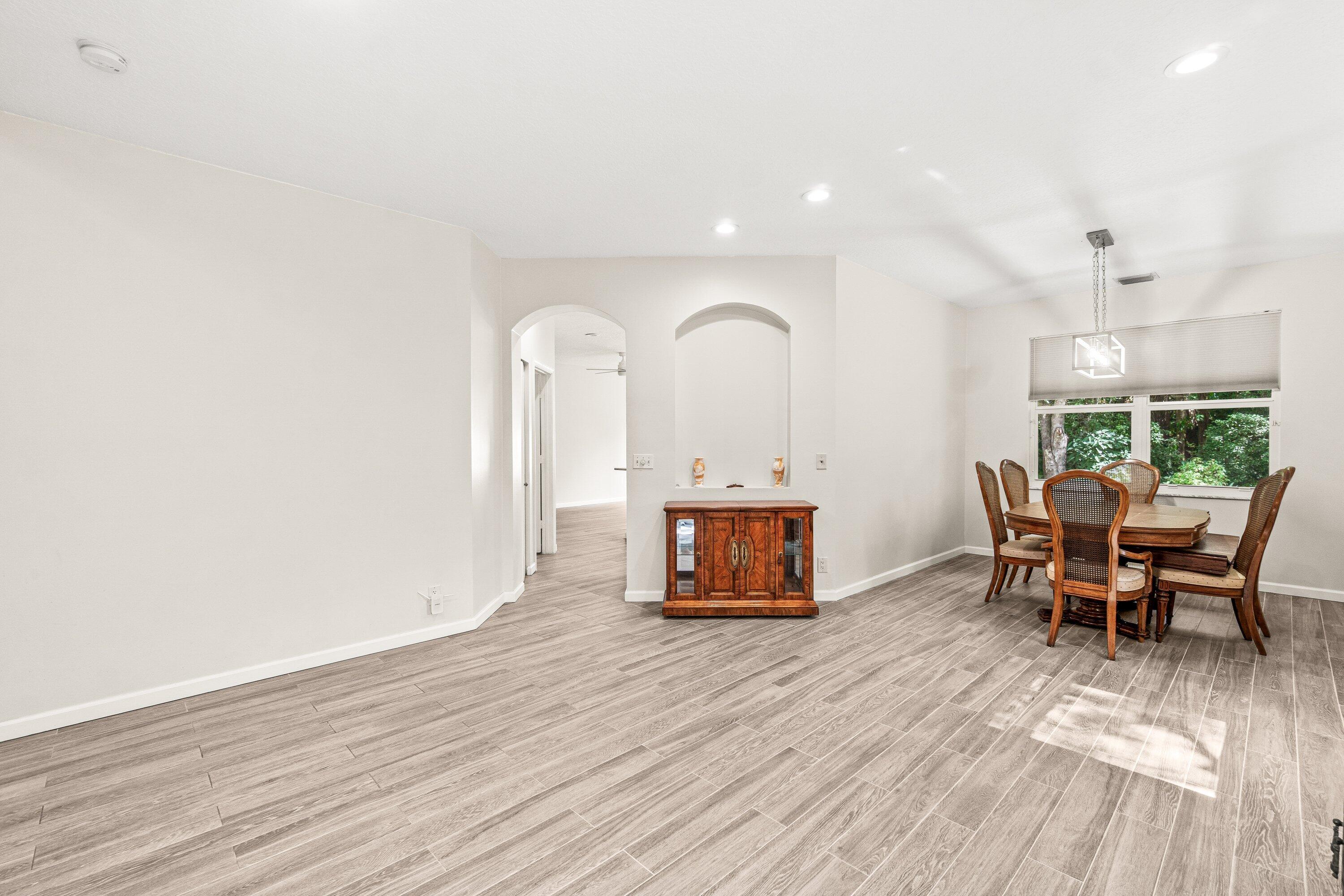 21256 Vía Fiore Boca Raton, FL 33433 - Photo 7 of 42 a view of a dining room with furniture and wooden floor