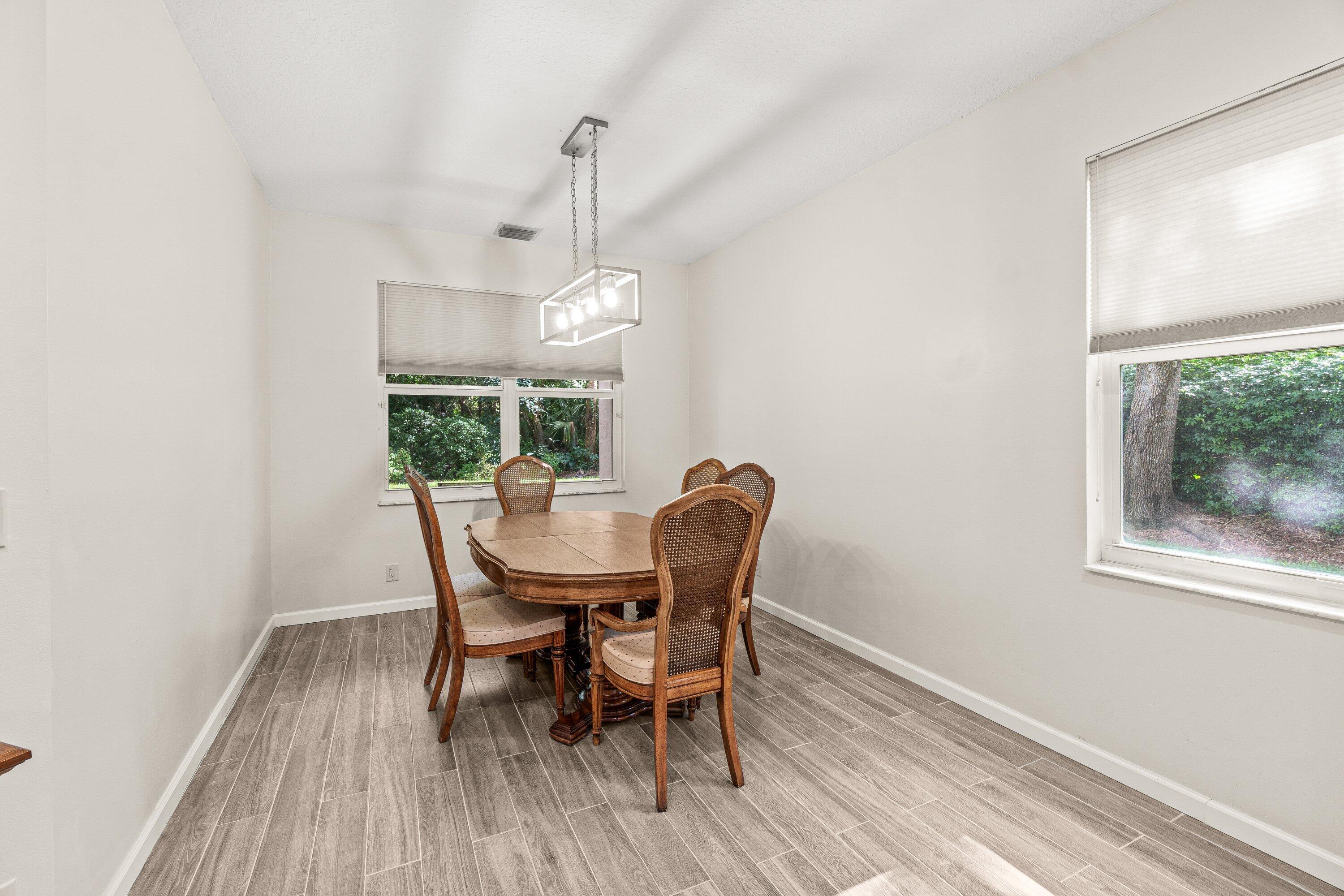 21256 Vía Fiore Boca Raton, FL 33433 - Photo 8 of 42 a view of a dining room with furniture window and wooden floor