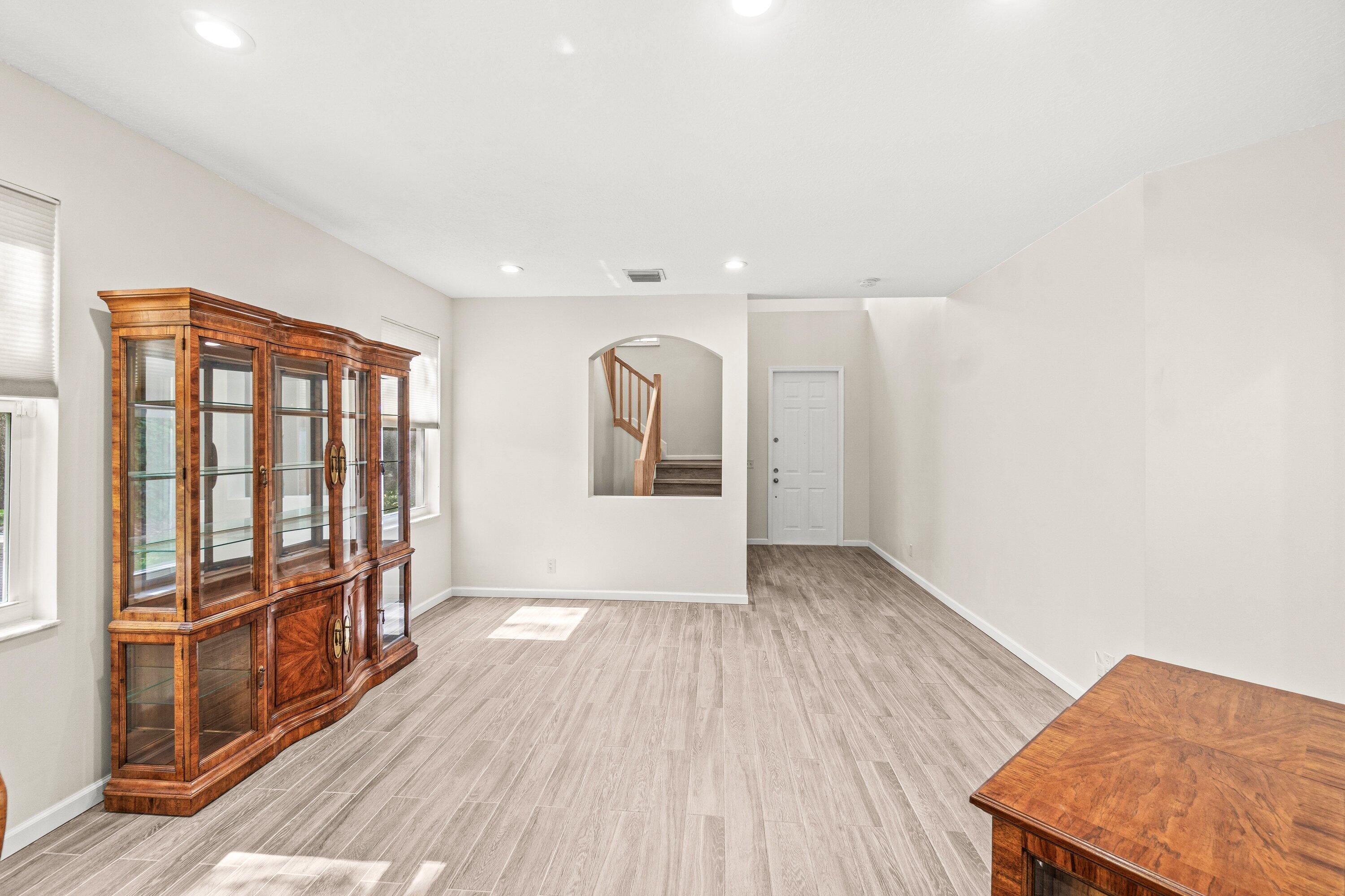21256 Vía Fiore Boca Raton, FL 33433 - Photo 9 of 42 wooden floor in an empty room with a window