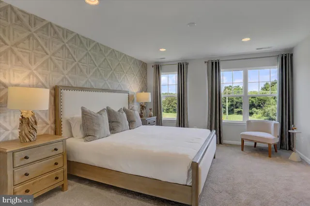 a spacious bedroom with a bed and a view of living room