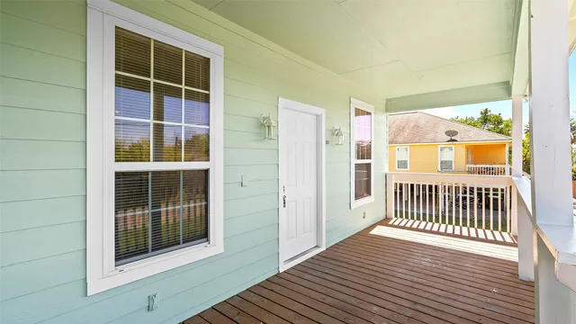 a view of porch with wooden floor and a window