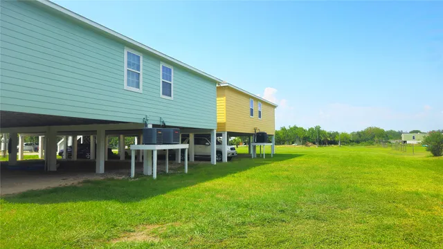 a view of a house with a backyard porch and sitting area