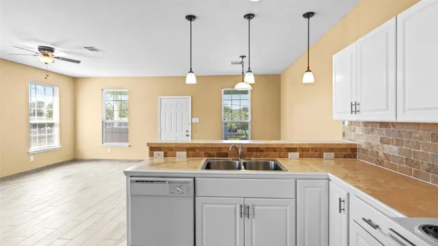 a view of a kitchen with a sink cabinets and a window