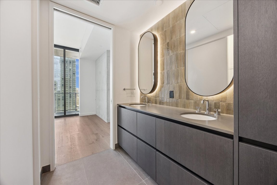 610 Davis Street, Unit 2409 Austin, TX 78701 - Photo 15 of 39 a bathroom with a double vanity sink and a mirror