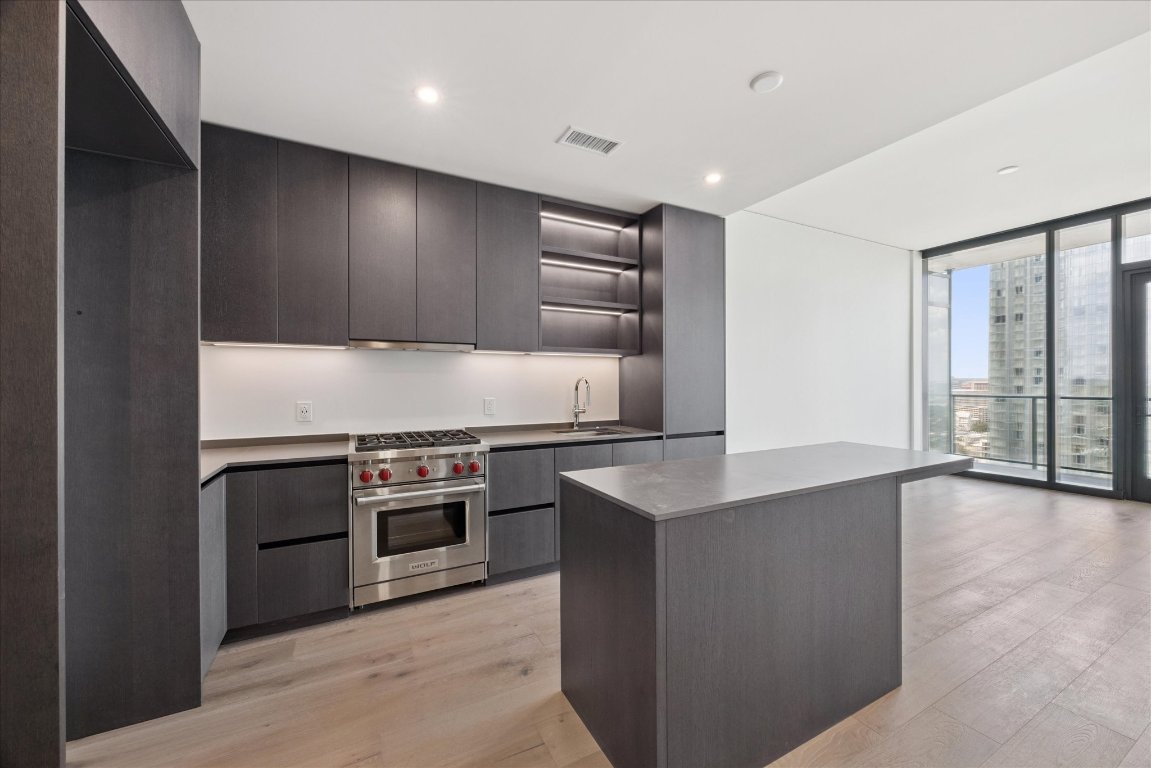 610 Davis Street, Unit 2409 Austin, TX 78701 - Photo 2 of 39 a kitchen with stainless steel appliances granite countertop a stove and a sink