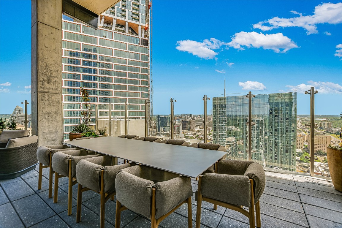 610 Davis Street, Unit 2409 Austin, TX 78701 - Photo 34 of 39 a dining room with furniture and a floor to ceiling window