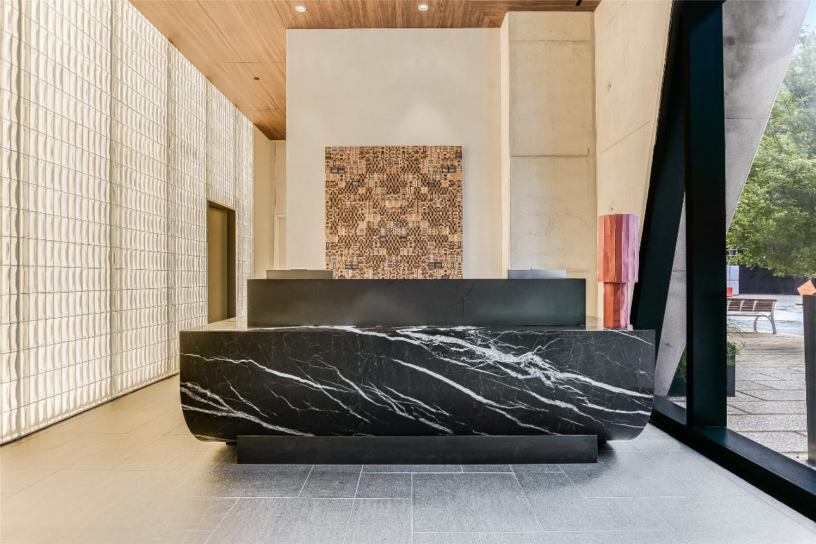 610 Davis Street, Unit 2409 Austin, TX 78701 - Photo 36 of 39 a bed sitting in a room next to a window