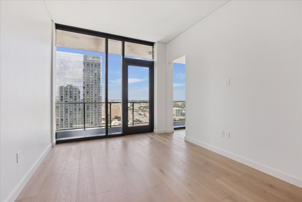610 Davis Street, Unit 2409 Austin, TX 78701 - Photo 9 of 39 a view of an empty room with wooden floor and a window