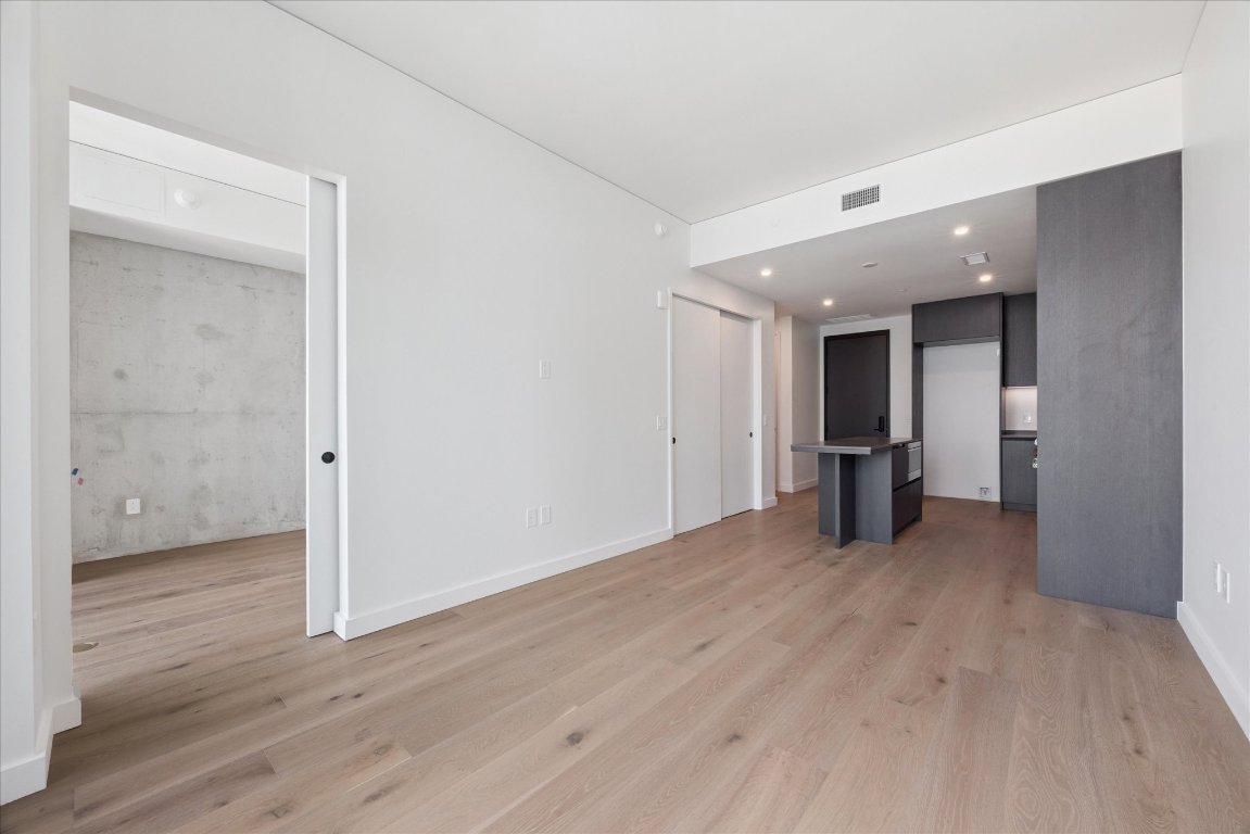 610 Davis Street, Unit 2409 Austin, TX 78701 - Photo 10 of 39 a view of a big room with wooden floor and windows