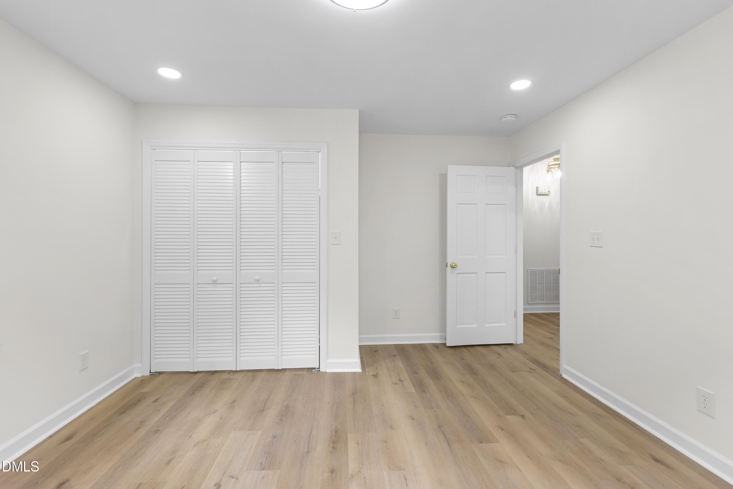 2168 Lakewood Falls Road Goldston, NC 27252 - Photo 16 of 30 a view of an empty room with wooden floor