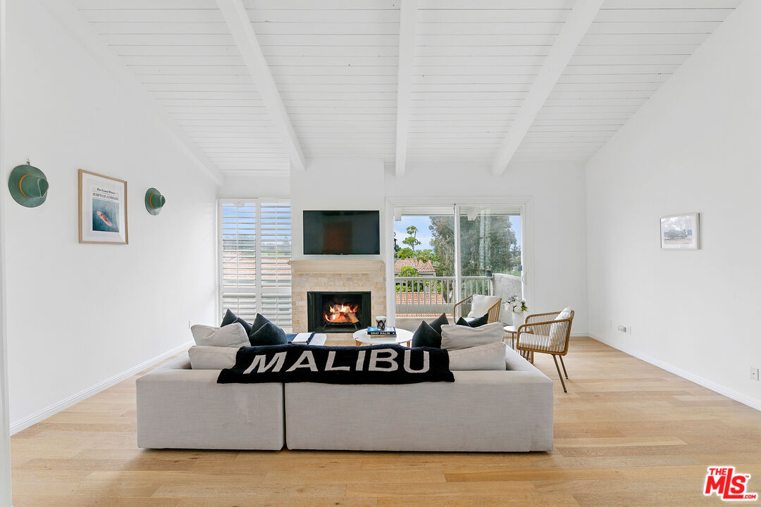 28398 Rey De Copas Lane Malibu, CA 90265 - Photo 11 of 44 a living room with furniture and a fireplace