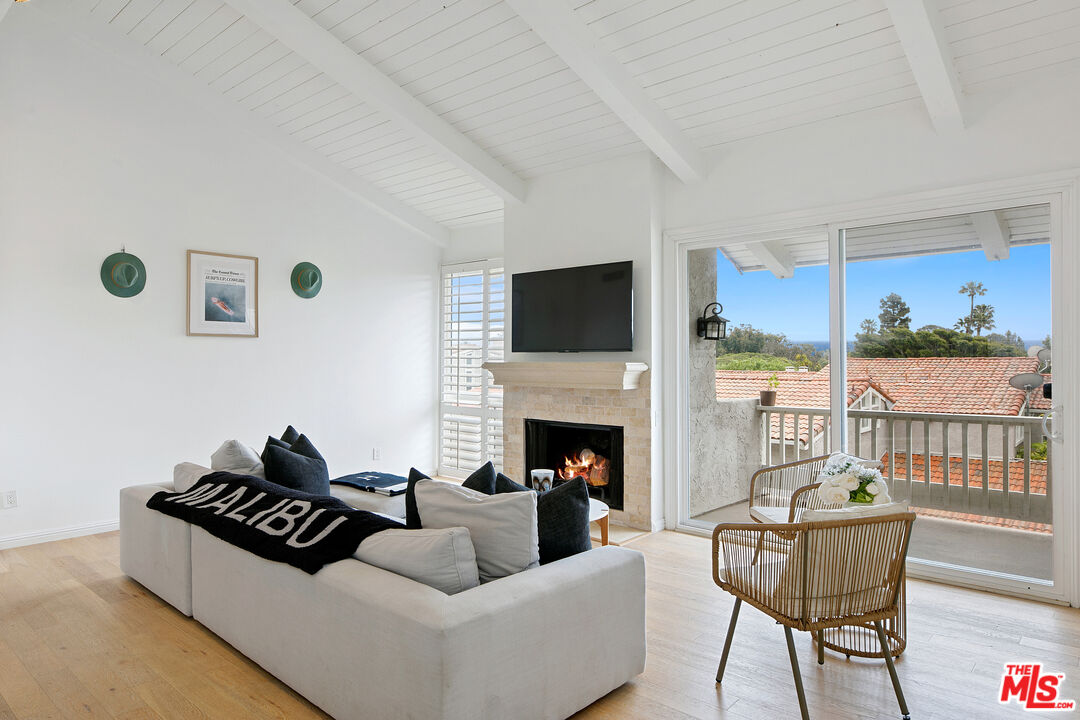 28398 Rey De Copas Lane Malibu, CA 90265 - Photo 12 of 44 a living room with furniture and a fireplace