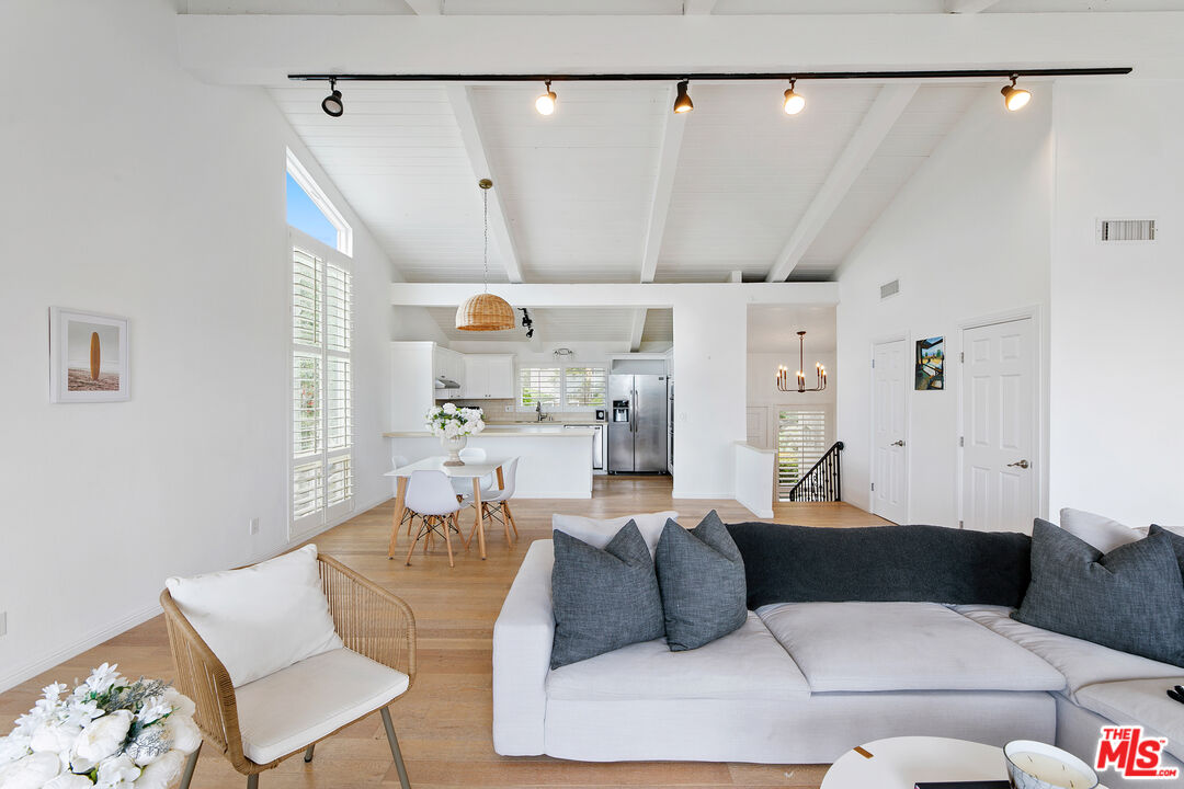 28398 Rey De Copas Lane Malibu, CA 90265 - Photo 15 of 44 a living room with furniture and a chandelier
