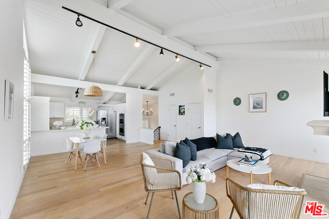 28398 Rey De Copas Lane Malibu, CA 90265 - Photo 16 of 44 a dining room with furniture and wooden floor